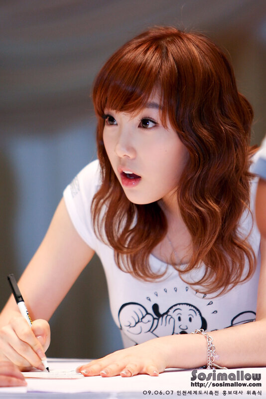 woman signing autograph