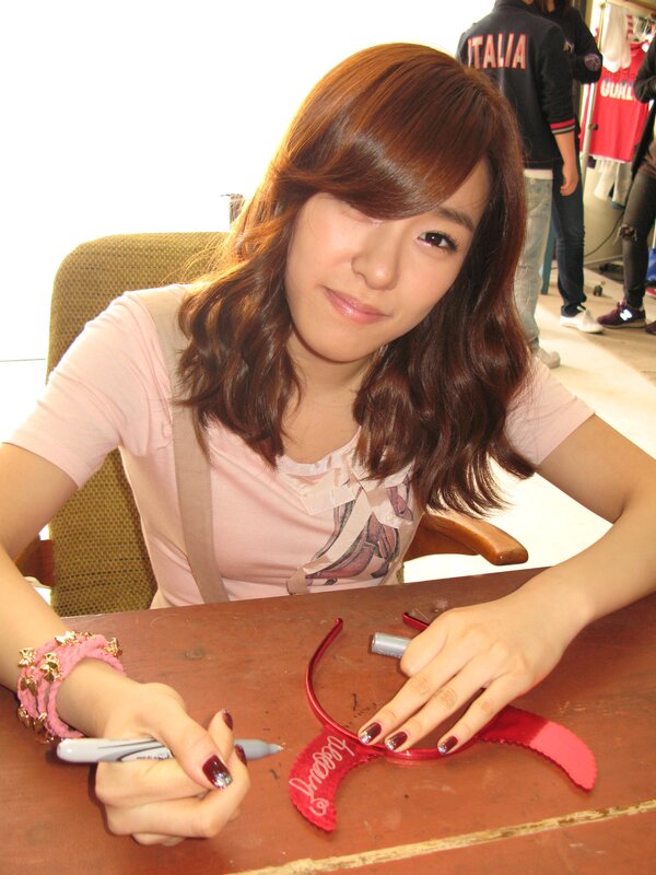 woman signing autograph