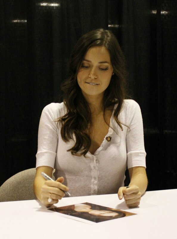 woman signing autograph