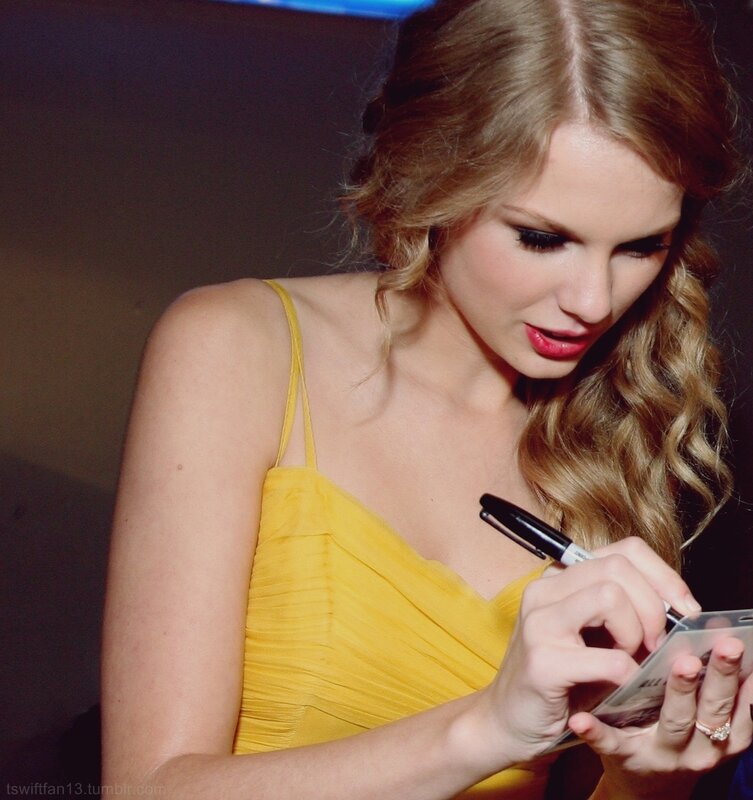 woman signing autograph