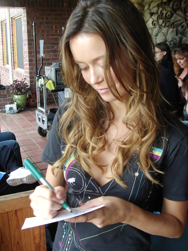 woman signing autograph