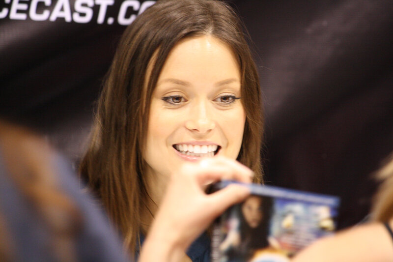 woman signing autograph at event