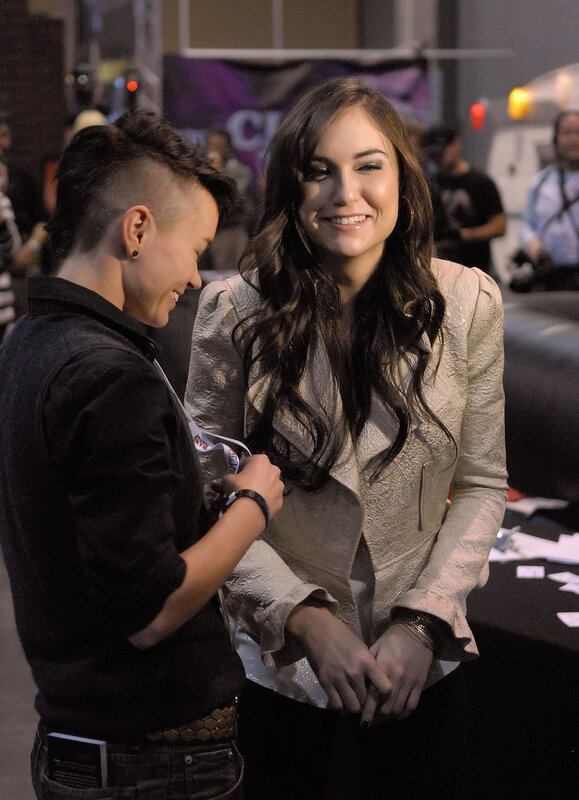 woman signing autograph at event
