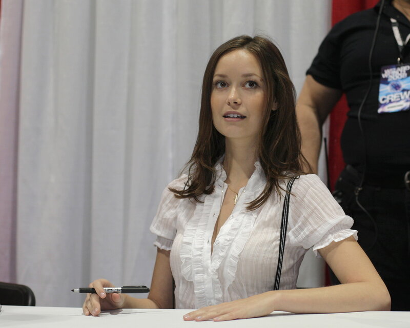 woman signing autograph at event