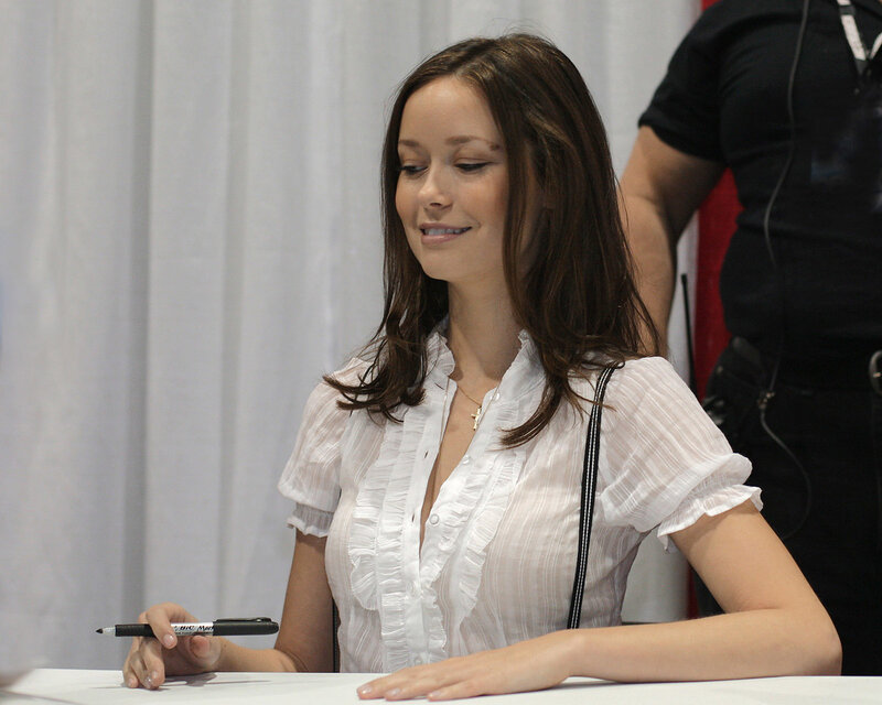 woman signing autograph at event