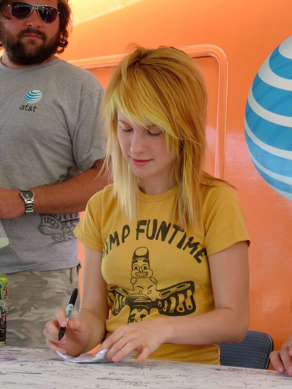 woman signing autograph at event