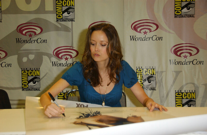 woman signing autograph at wondercon