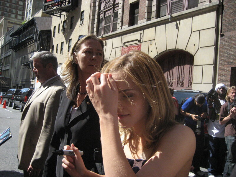 woman signing autograph outdoors