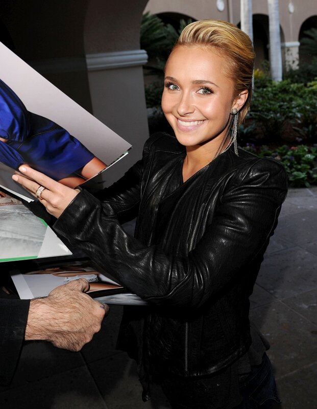 woman signing autographs
