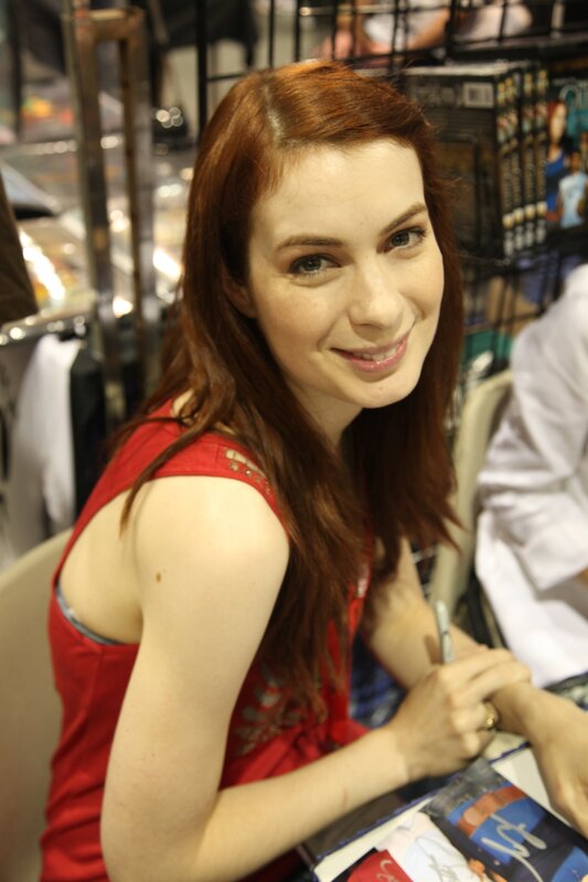 woman signing autographs at convention