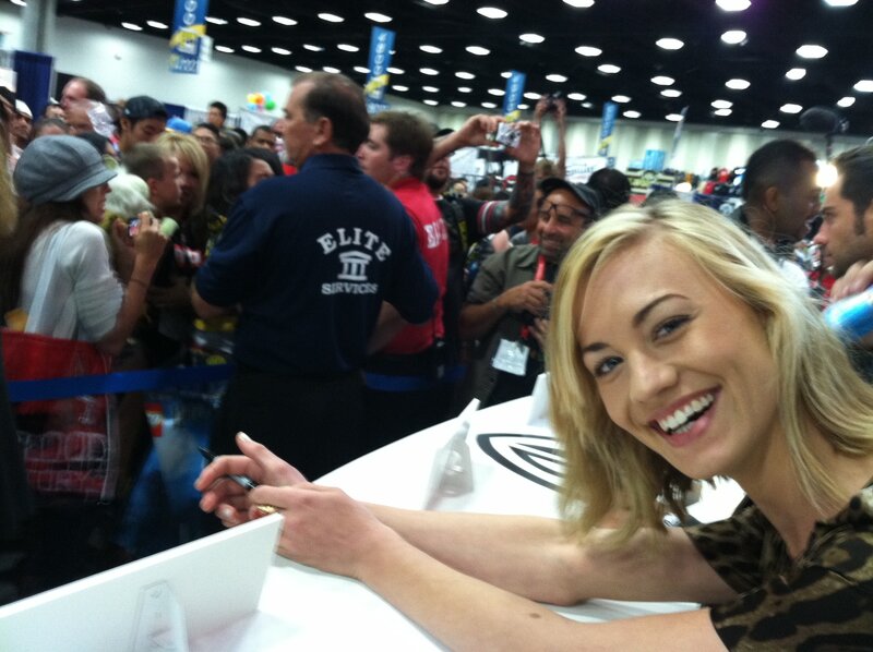 woman signing autographs at convention