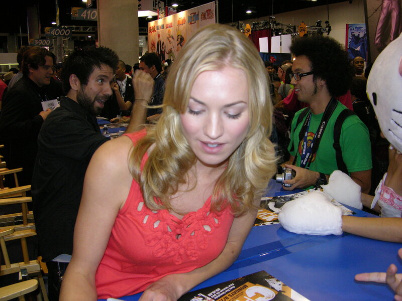 woman signing autographs at convention