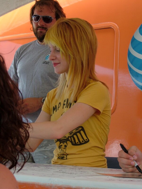 woman signing autographs at event