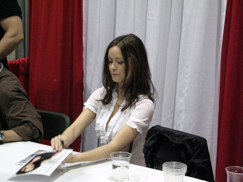 woman signing autographs at event