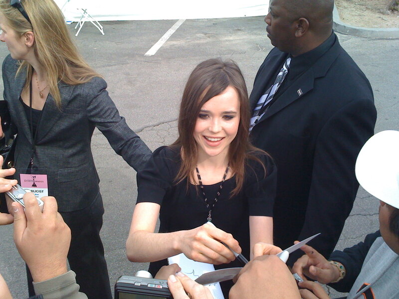 woman signing autographs at event
