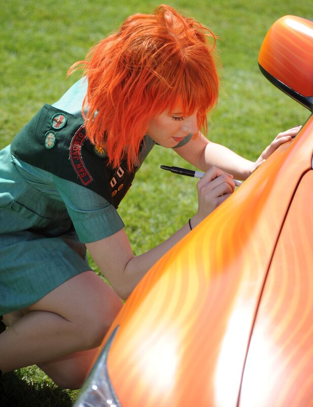 woman signing car with marker