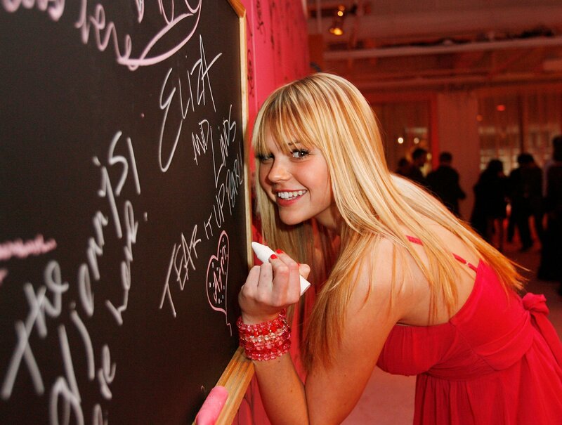 Woman signing chalkboard at event