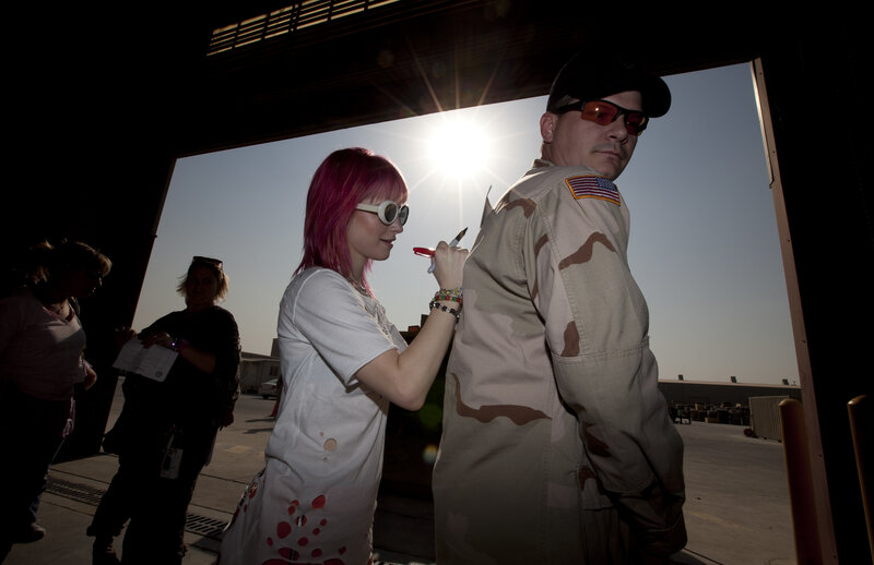 Woman signing military uniform