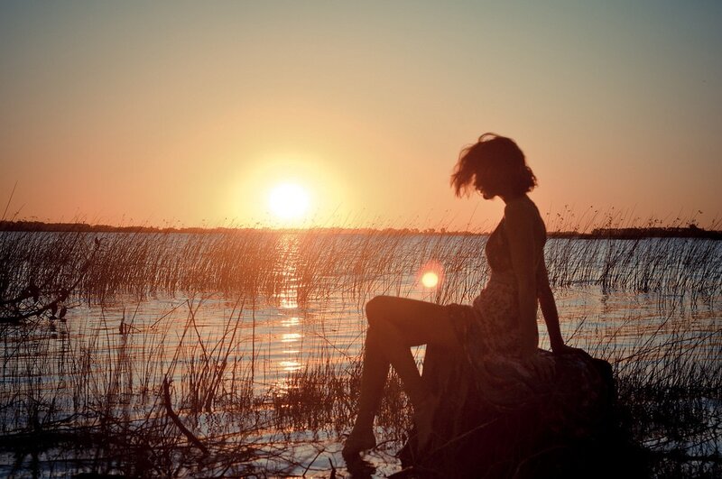 Woman silhouetted at sunset