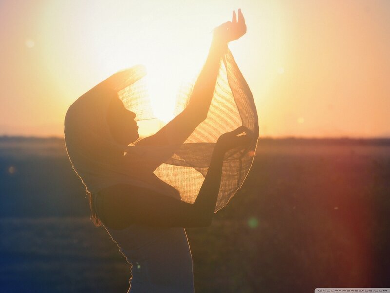 woman silhouetted at sunset