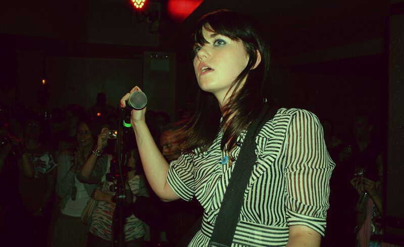 Woman singing at a concert