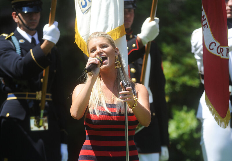 Woman singing at a military event