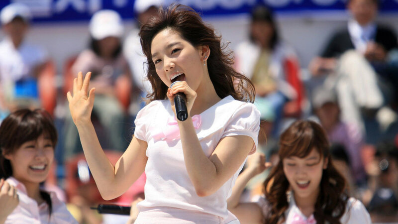 woman singing at outdoor event
