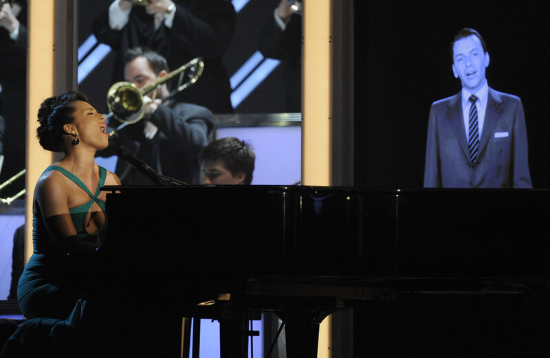 Woman singing at piano on stage