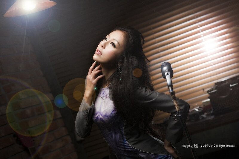 woman singing in a dimly lit room