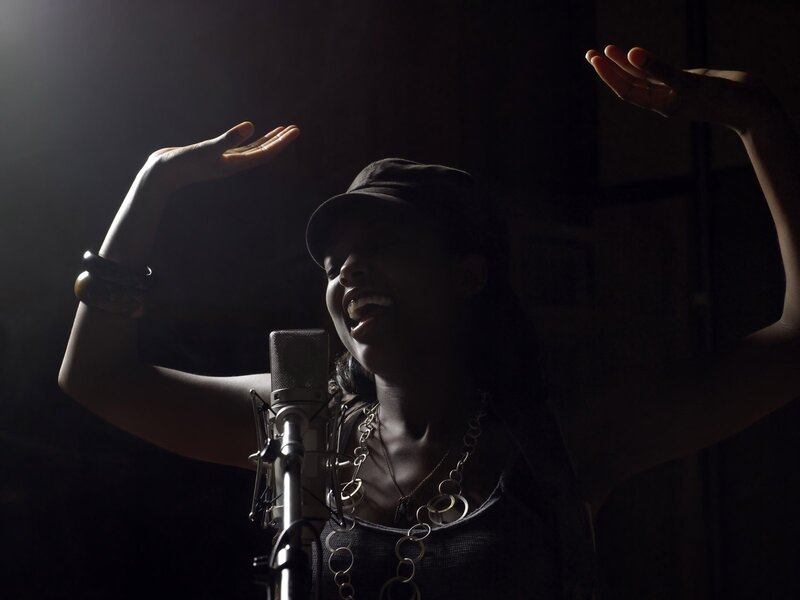 woman singing in a recording studio