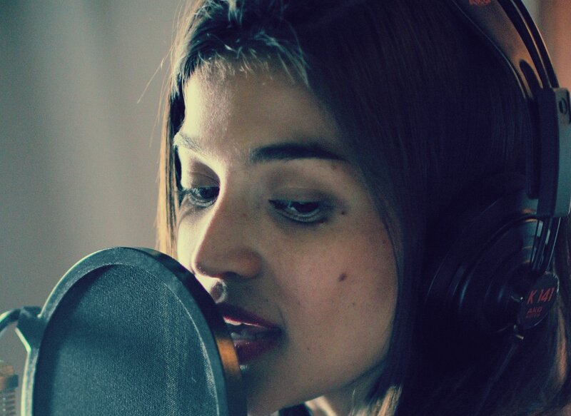 woman singing in recording studio