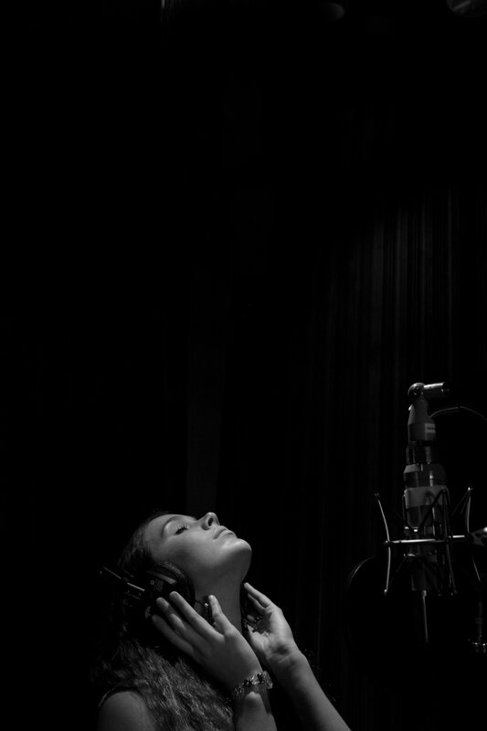 woman singing in recording studio