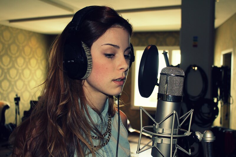 woman singing in recording studio