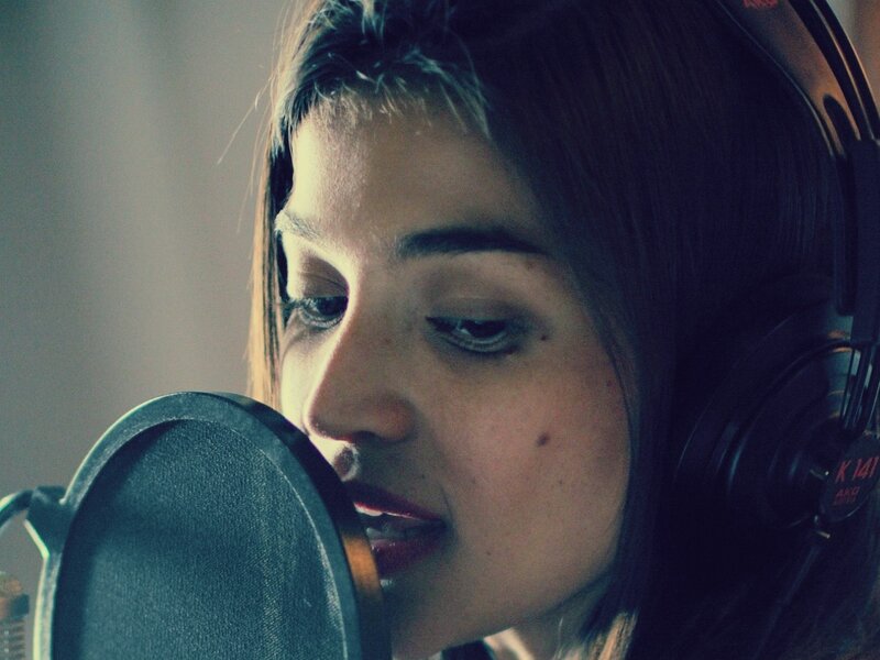 woman singing in recording studio