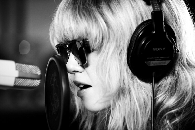 woman singing in recording studio