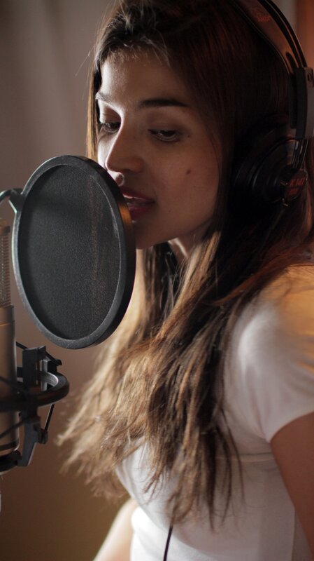 woman singing in recording studio