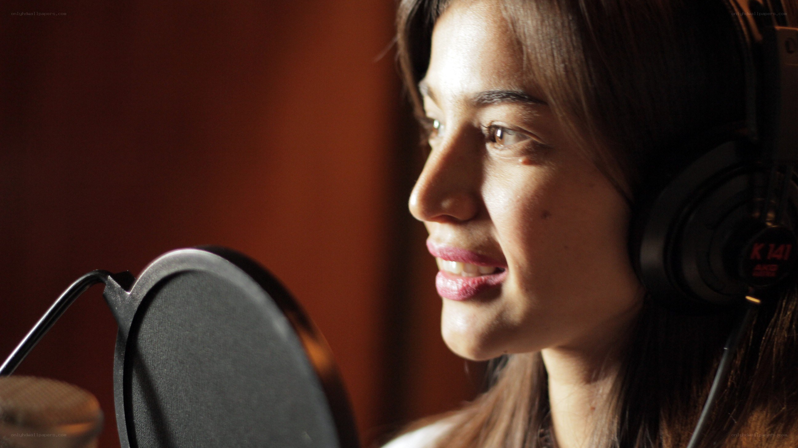 woman singing in recording studio