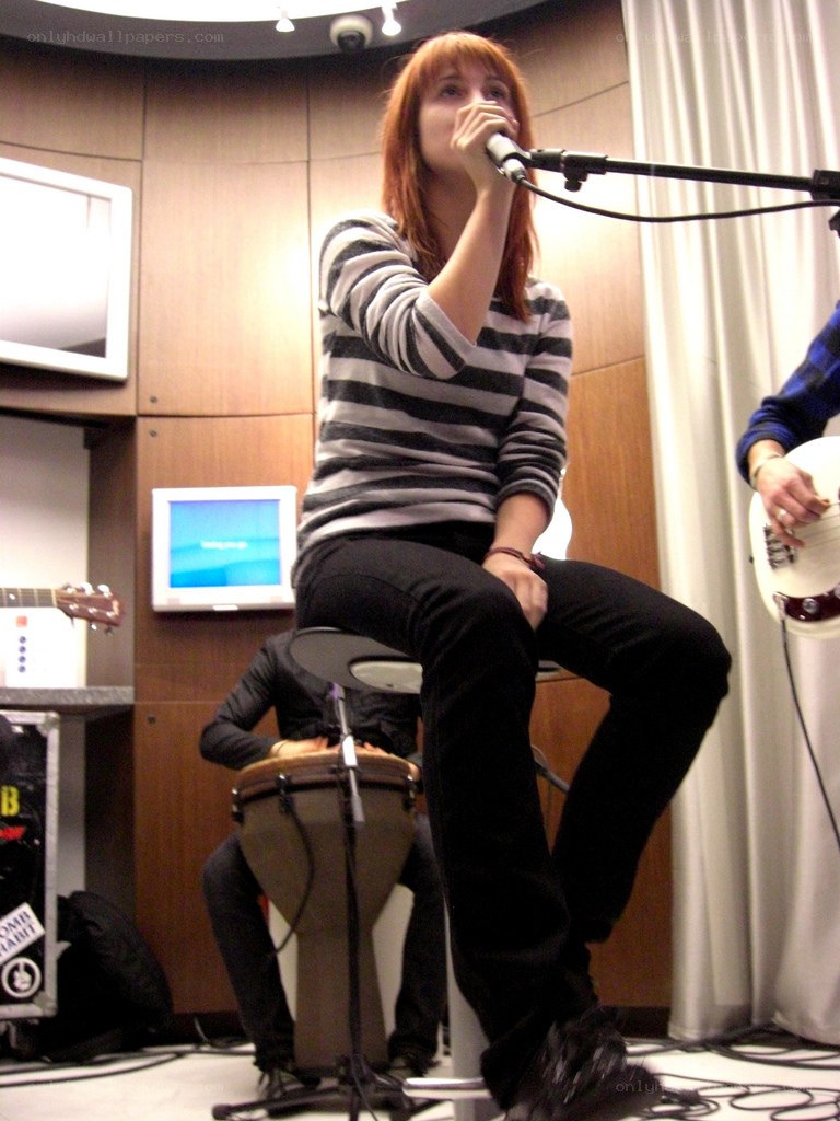 Woman singing into a microphone
