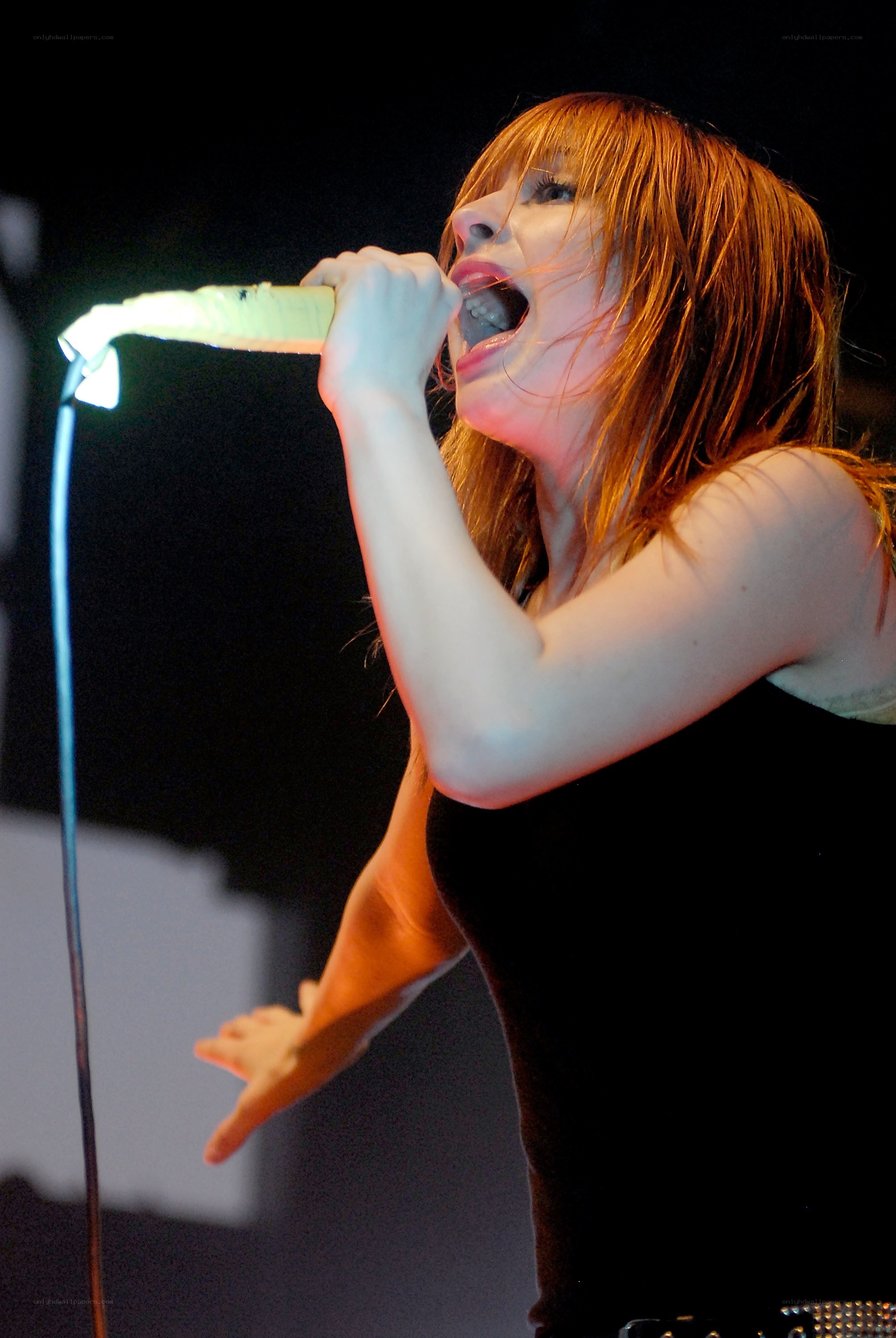 Woman singing into a microphone