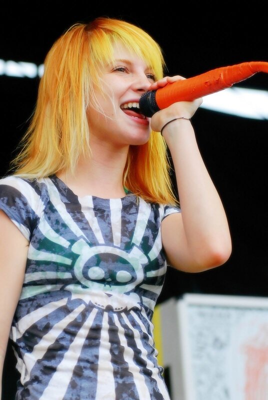 woman singing into carrot microphone