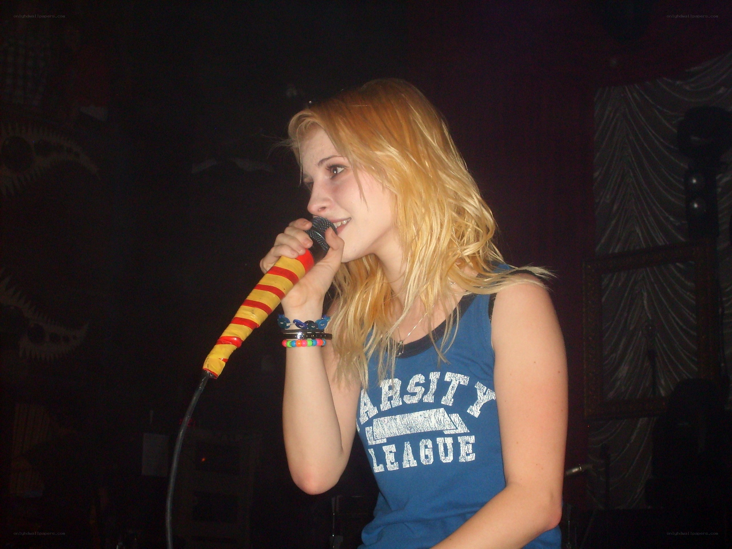 woman singing into microphone