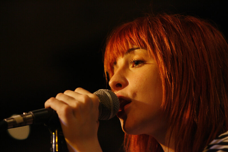 woman singing into microphone