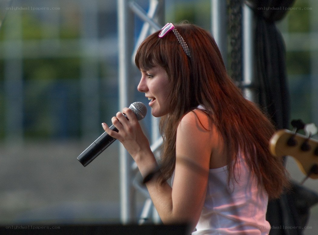 woman singing into microphone