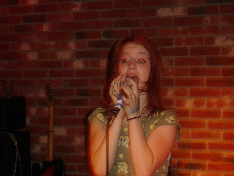 woman singing into microphone