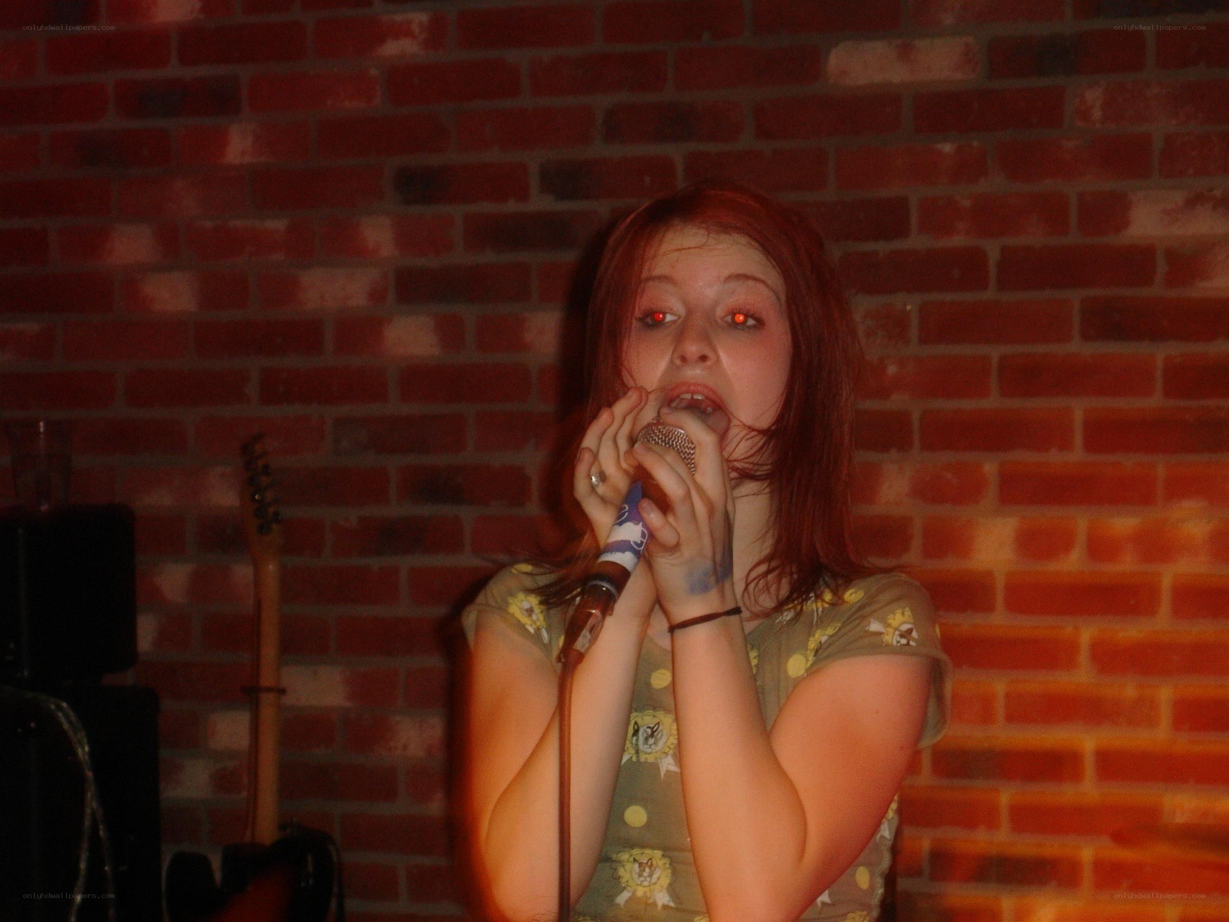 woman singing into microphone