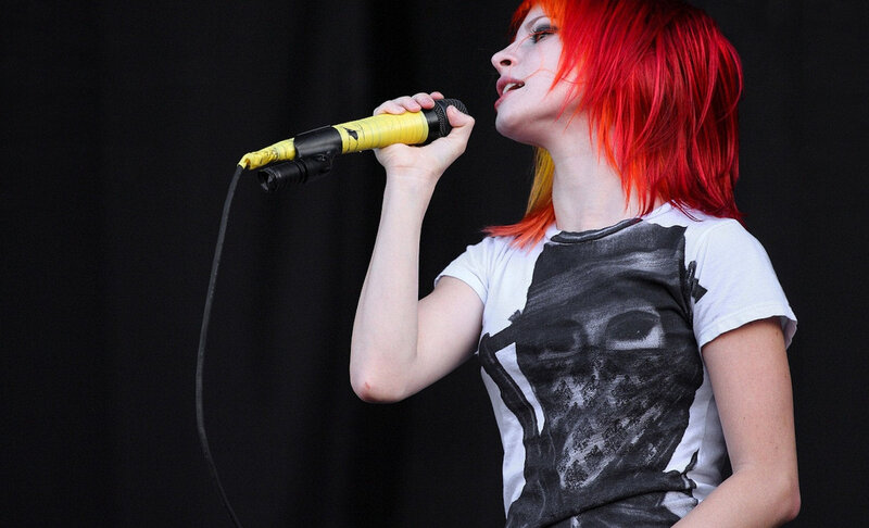 woman singing into microphone