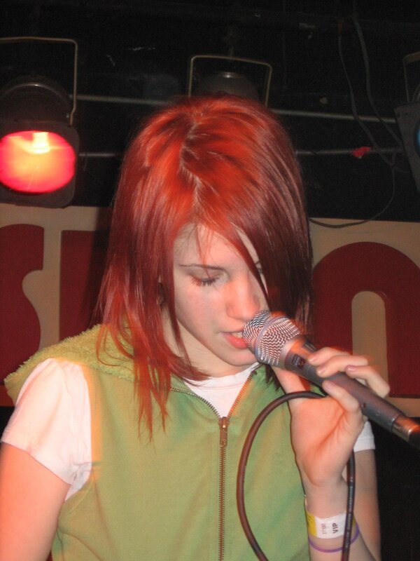 woman singing into microphone