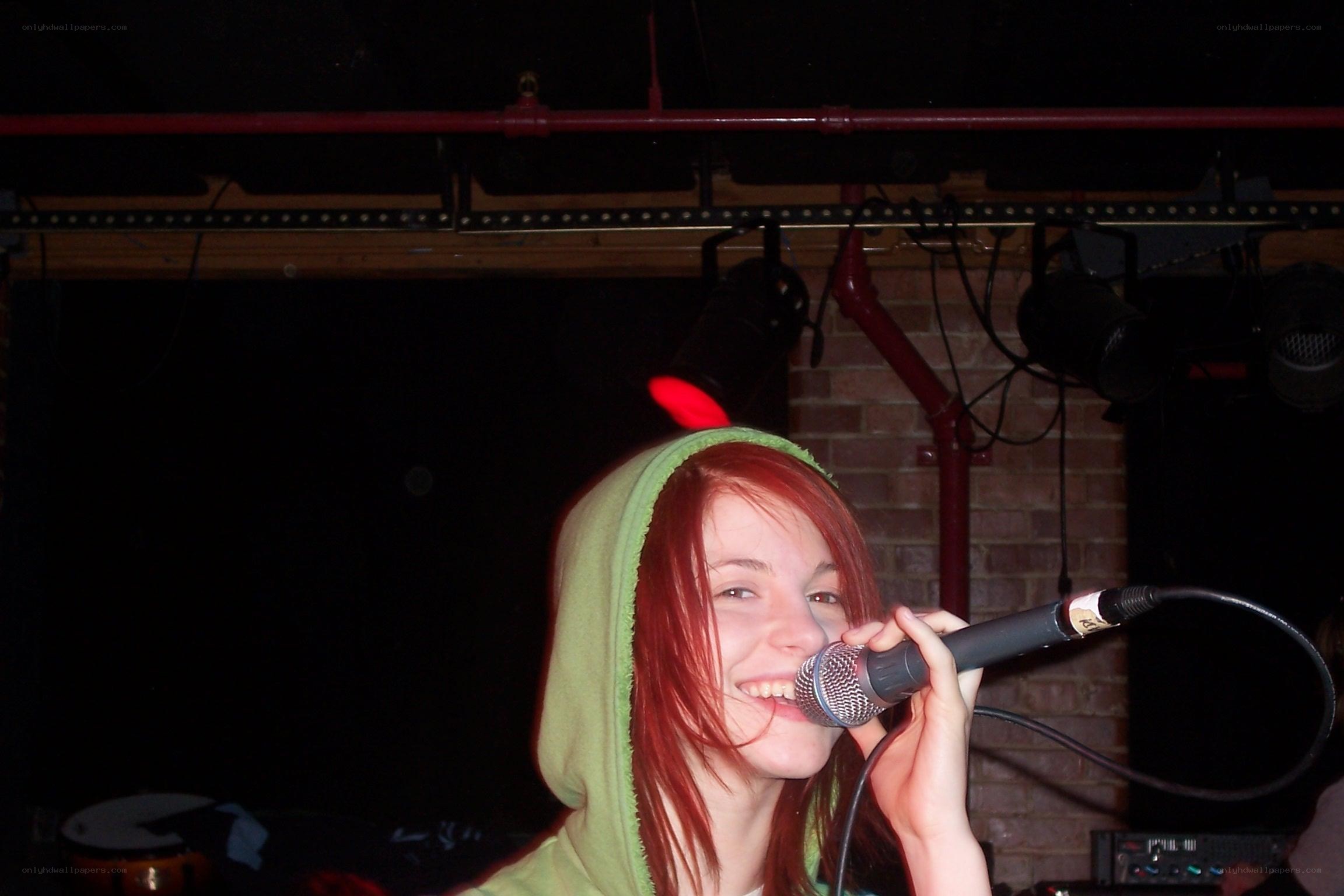 woman singing into microphone