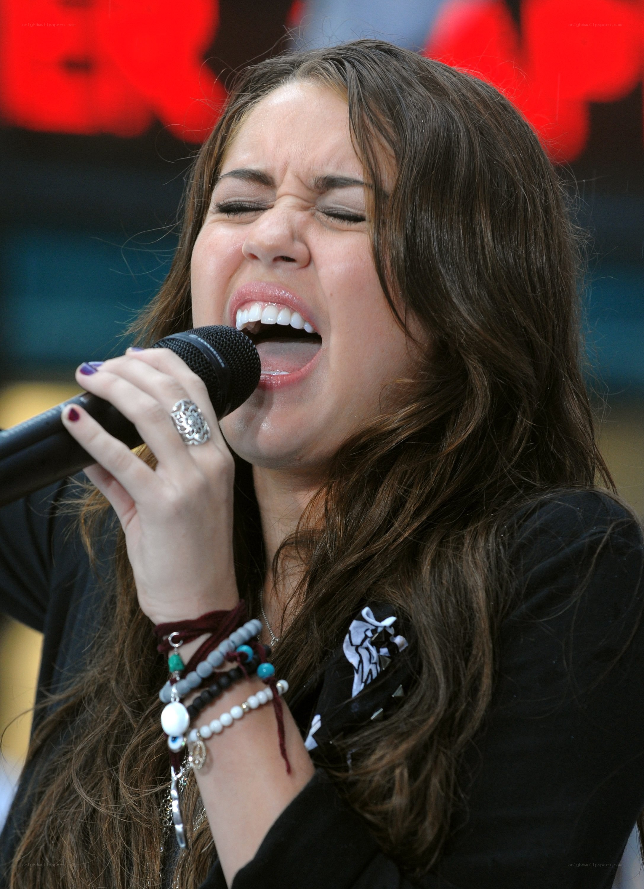 woman singing into microphone