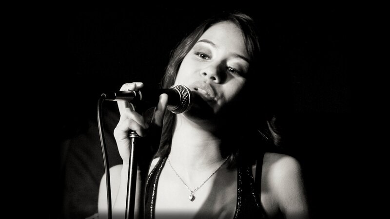 woman singing into microphone